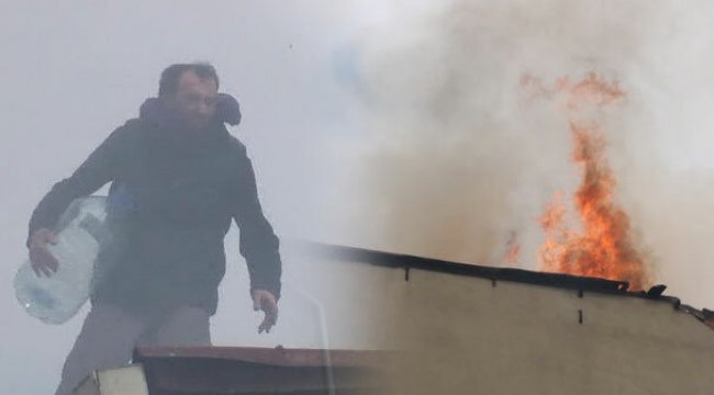 Yanan çatıya damacana ile müdahele etti