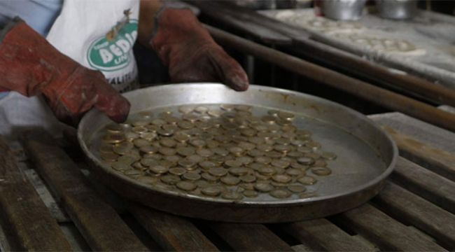 Madeni paraları 180 derecede ısıttıktan sonra müşterilere veriyor