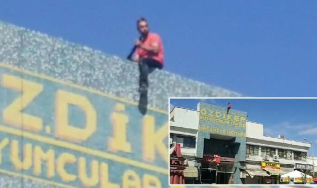 İş yerinin açılması için çatıda benzin ve tüfekle eylem yaptı, polis ikna edip indirdi